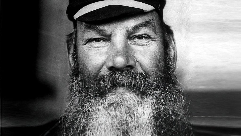 A portrait of WG Grace, wearing his iconic beard and cricket attire.